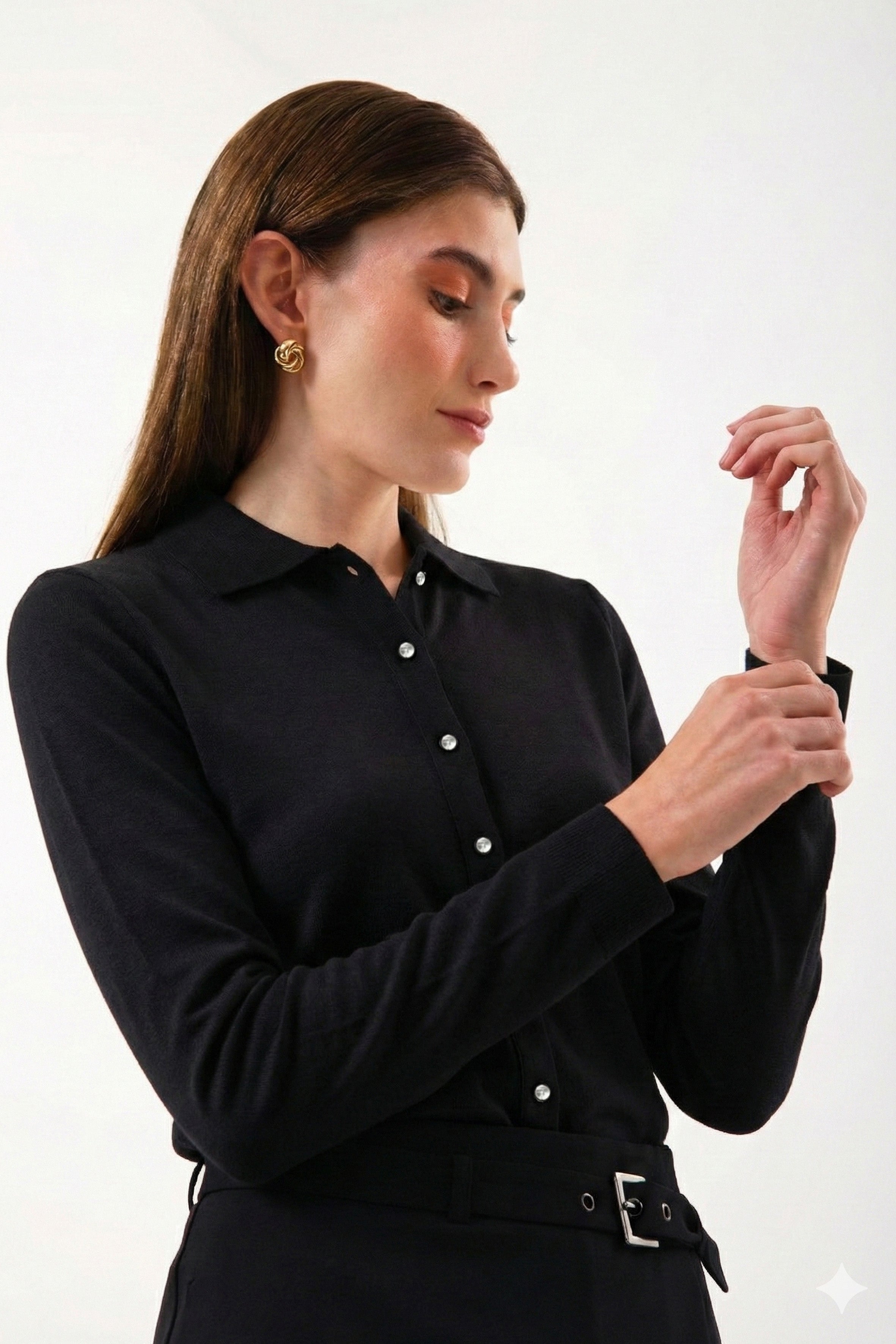 Zamansız siyah rengin güçlü duruşu, modern ve dar kalıp gömlek tasarımıyla buluşuyor. %100 organik pamuktan üretilen bu gömlek, vücuda net bir siluet kazandırırken sade çizgilerini tamamlayan gümüş düğme detayları ile sofistike bir görünüm sunar. Günlük kullanımdan özel anlara kadar uzanan çok yönlü yapısıyla, detaylarda şıklık ve doğal konfor arayanlar için zamansız bir gardırop parçasıdır.
