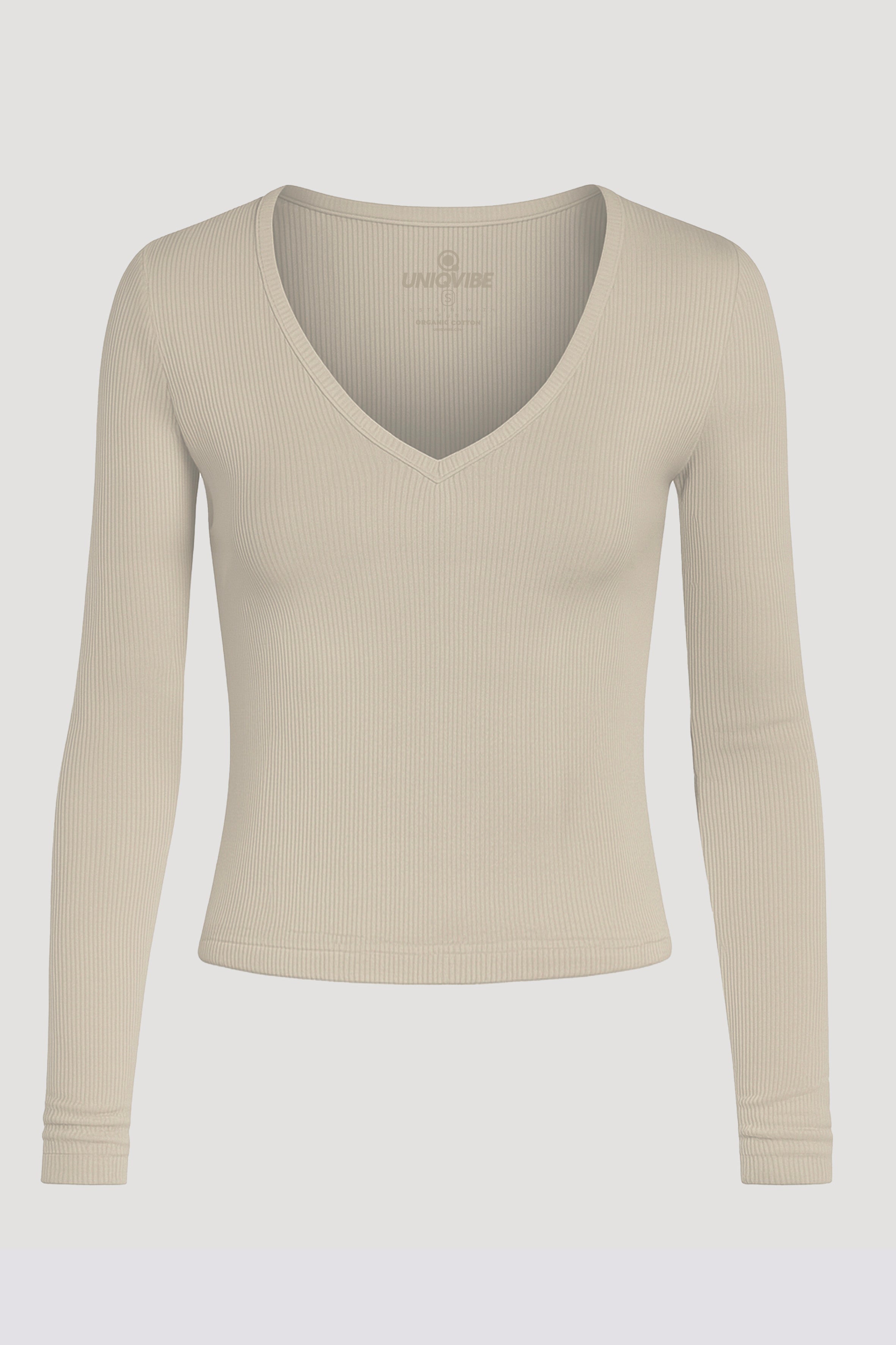 Organik pamuklu bej fitilli uzun kollu bluz. Yumuşak dokulu kumaşı ve esnek fitilli formuyla vücuda uyum sağlar. V yaka detayıyla sade ,modern bir görünüm sunar. Günlük stilin tamamlayıcısı olan bu parça, konforu ve şıklığı bir arada sunar.